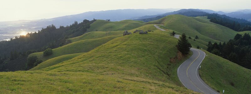 Winding road through green hills