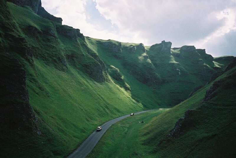 Winding road through green hills