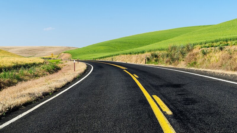 Winding road through green hills