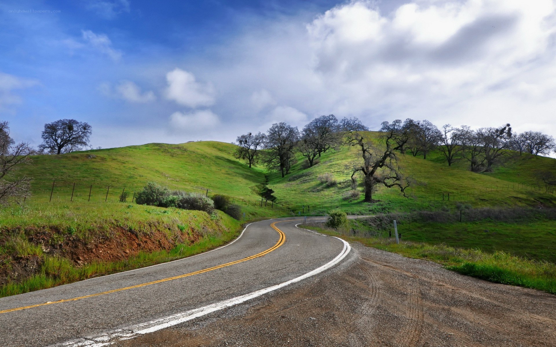 Winding road through green hills
