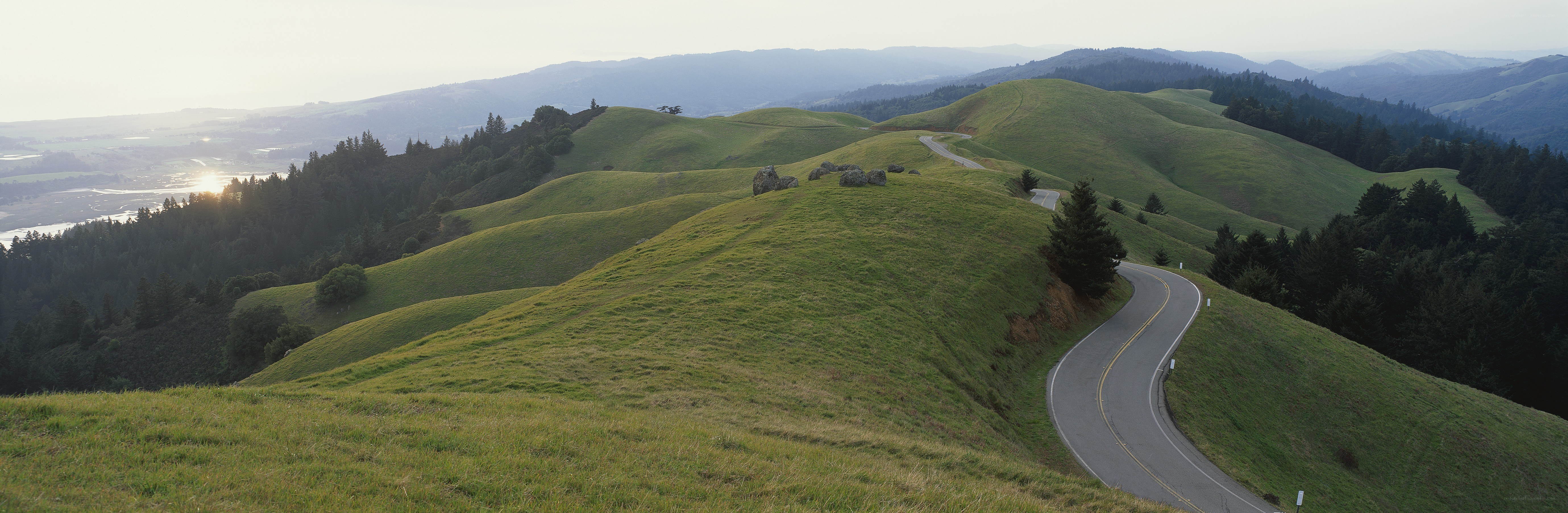 Winding road through green hills