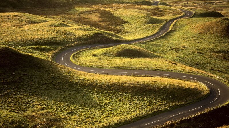 Winding road through green hills