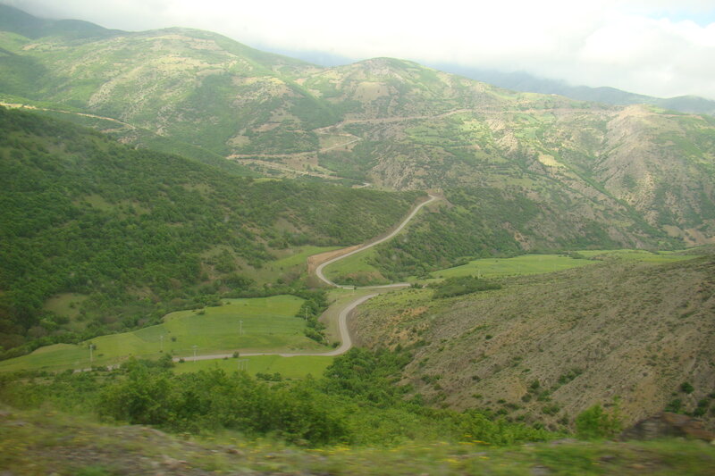 Winding road through green mountains