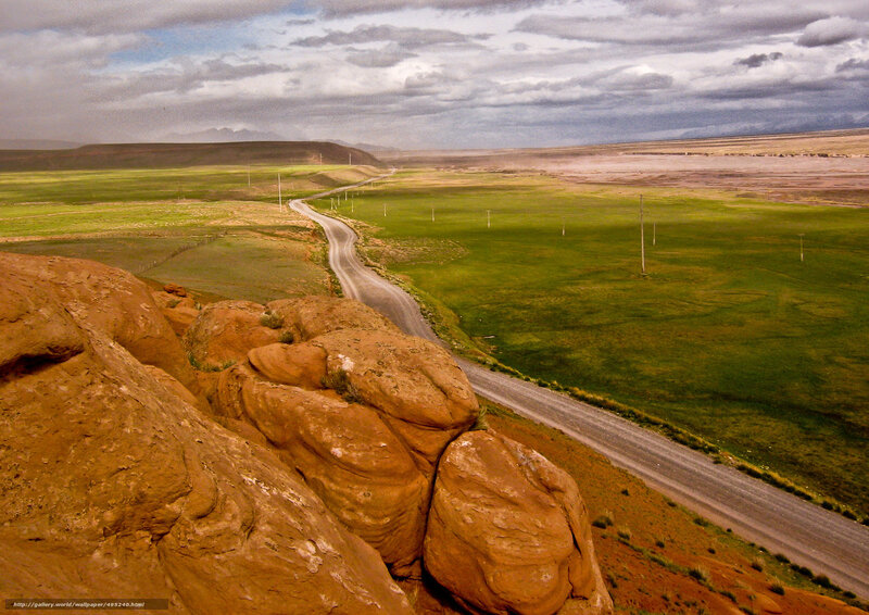Winding road through green plains