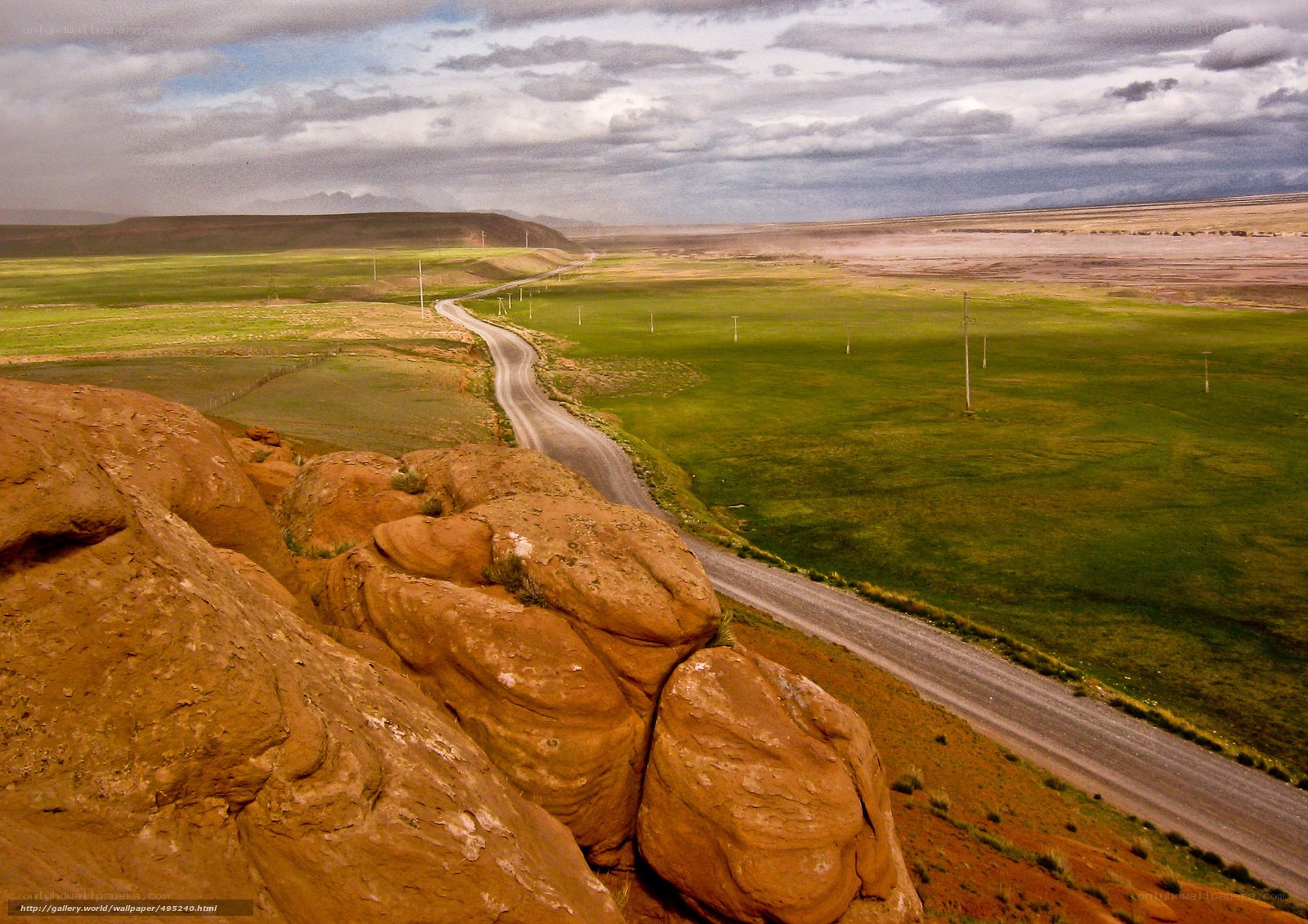 Winding road through green plains