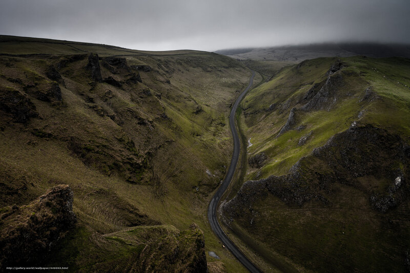 Winding road through green valley