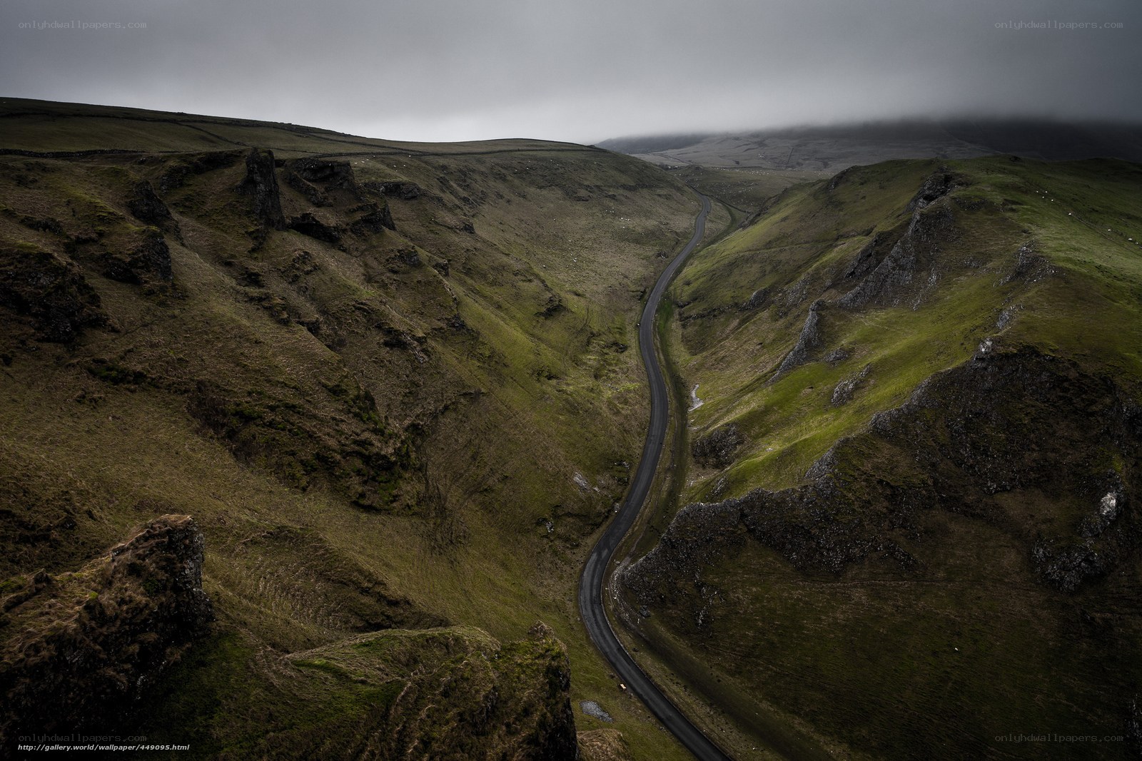 Winding road through green valley