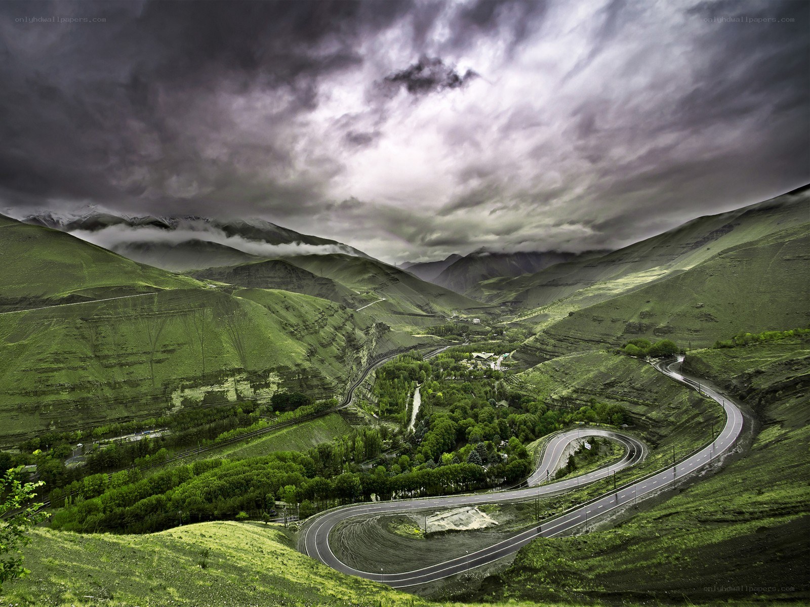 Winding road through green valley