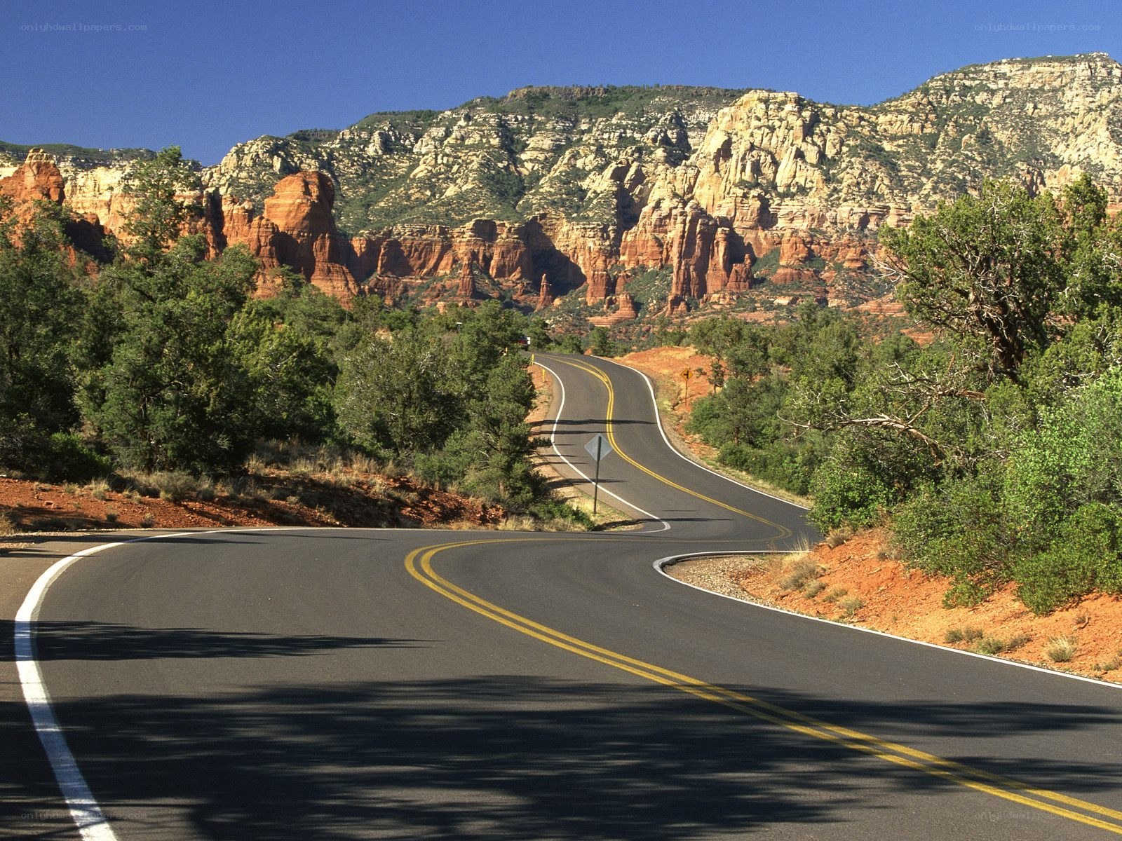 Winding road through red rock canyon