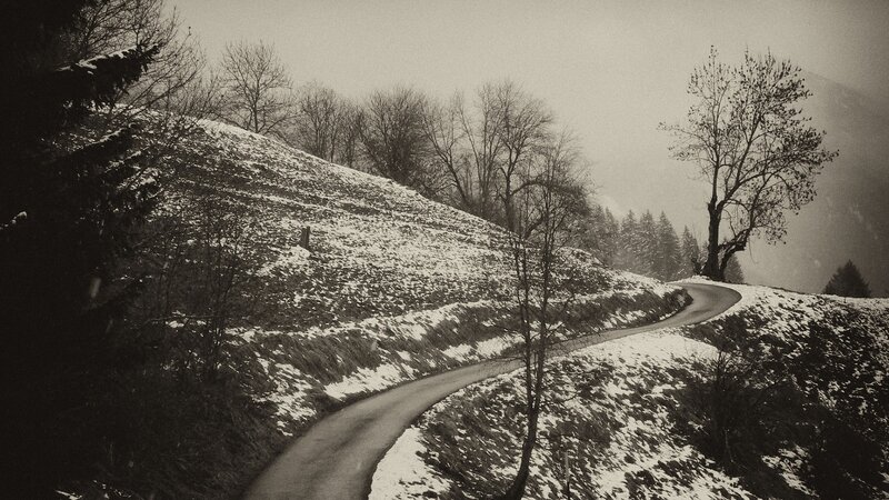 Winding road through snowy hills