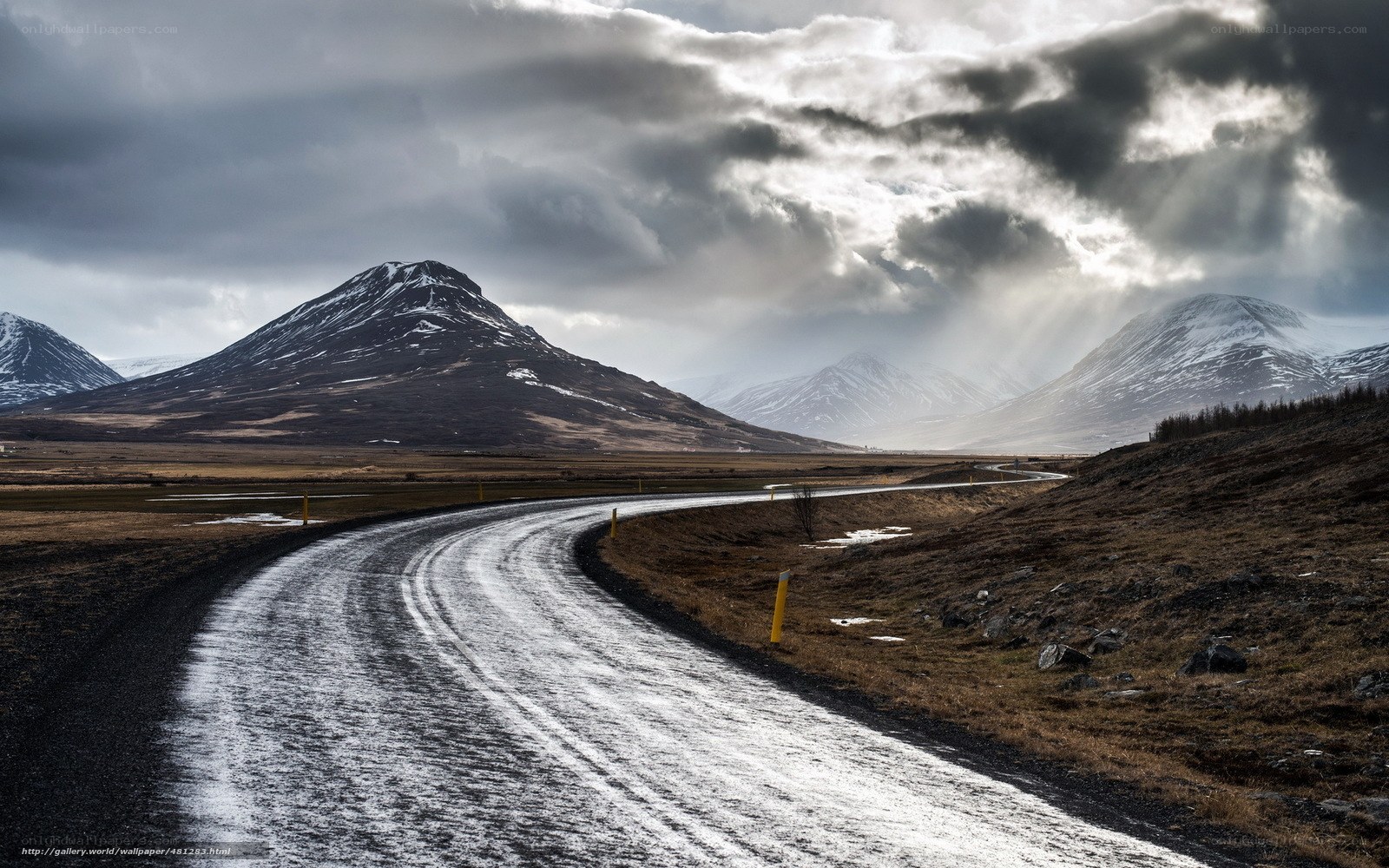Winding road through snowy mountains