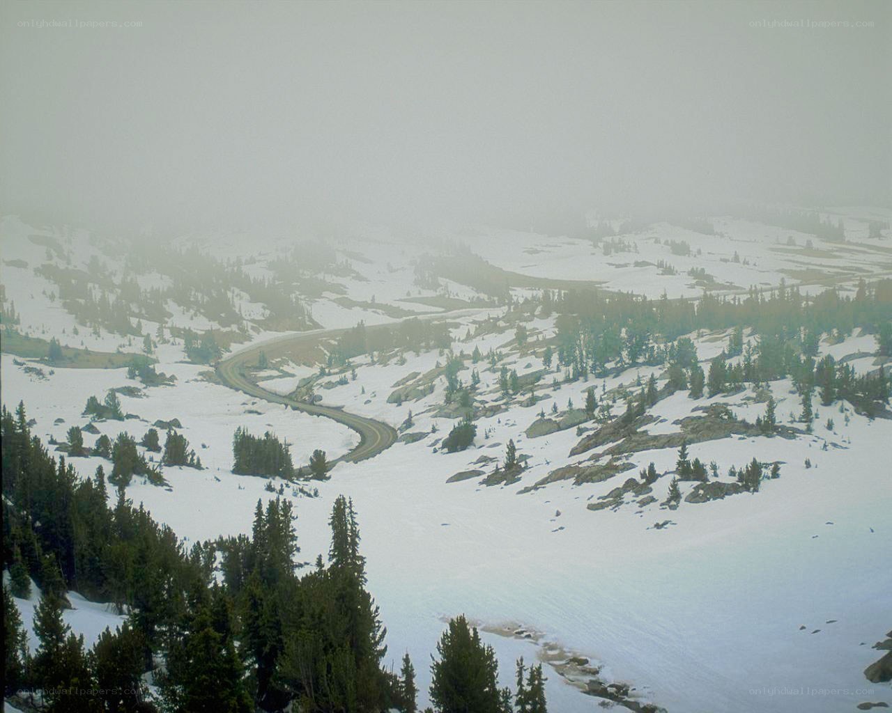 Winding road through snowy mountains