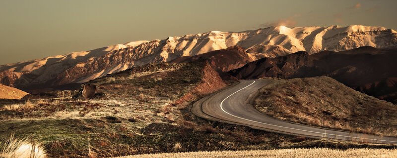 Winding road through snowy mountains