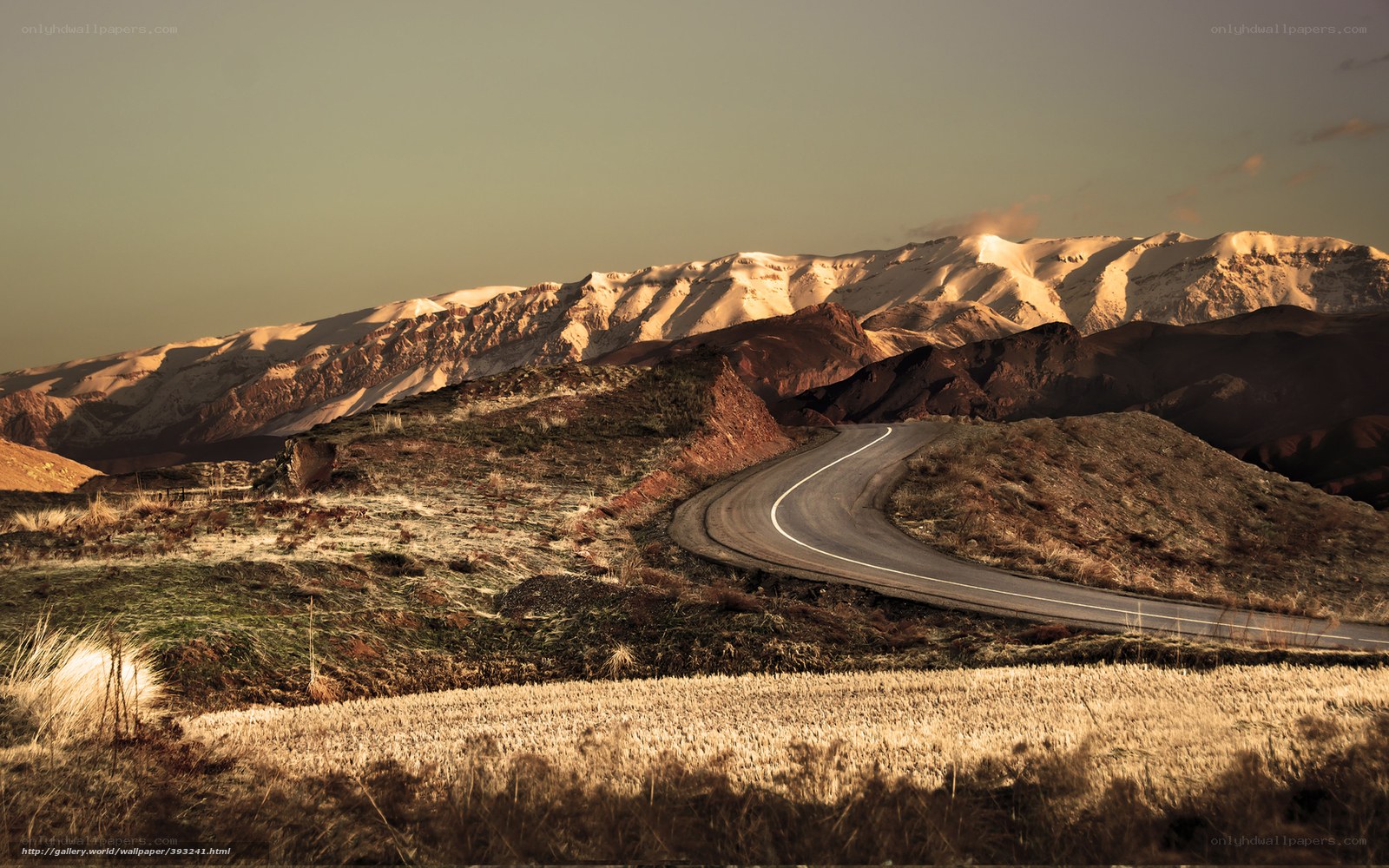 Winding road through snowy mountains