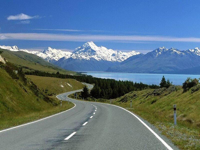 Winding road to snow-capped mountains