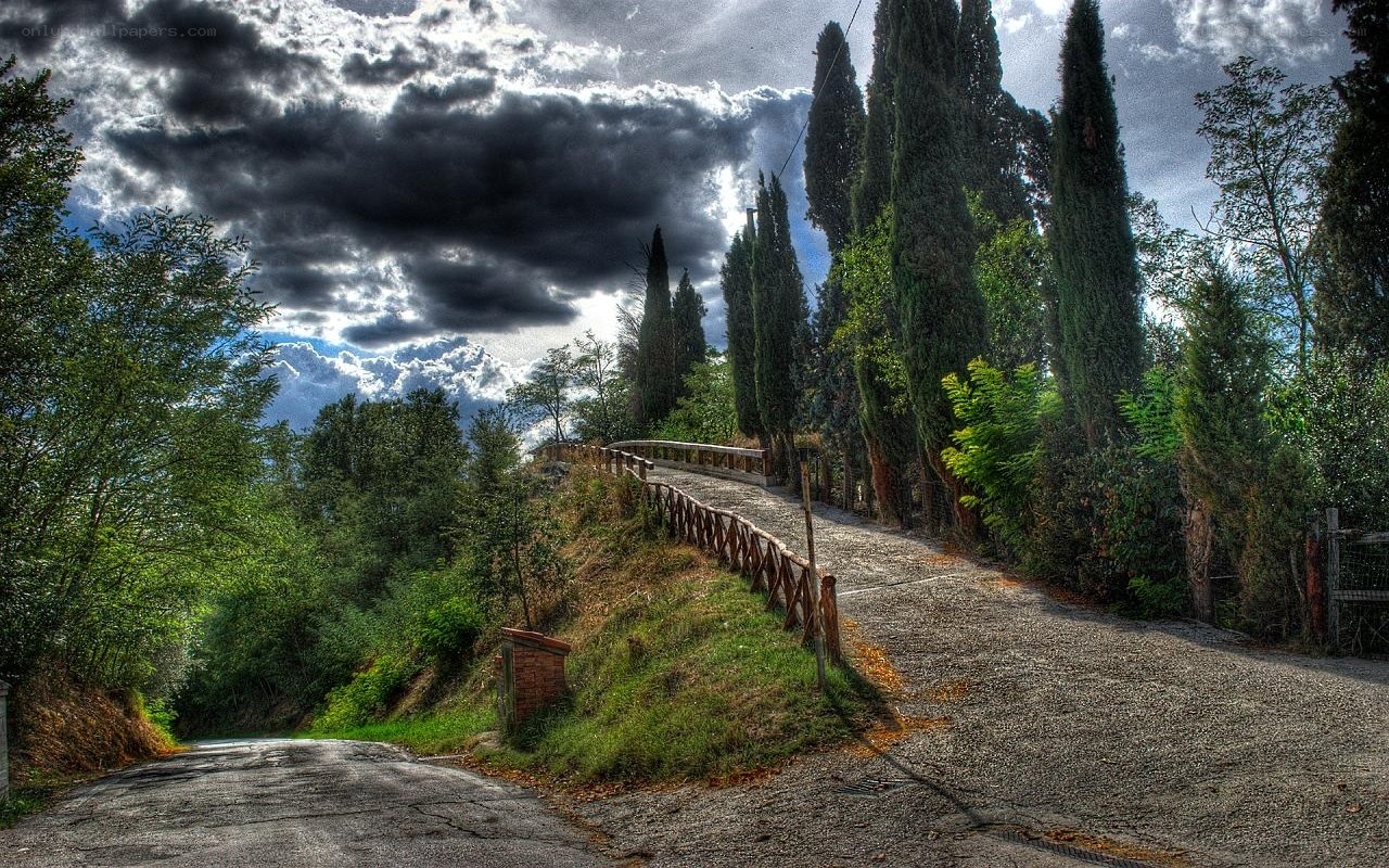 Winding road under stormy sky