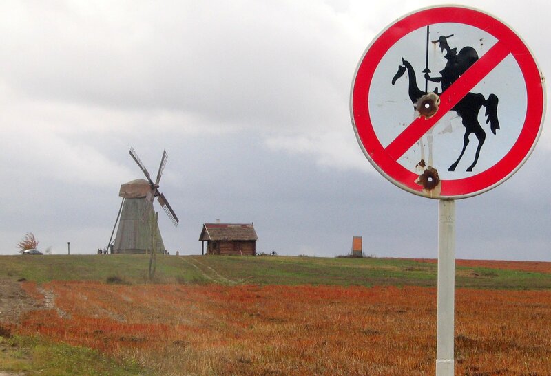 Windmill and sign on a hill