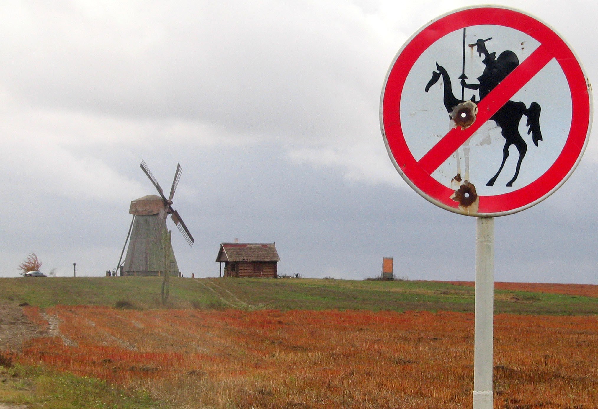 Windmill and sign on a hill