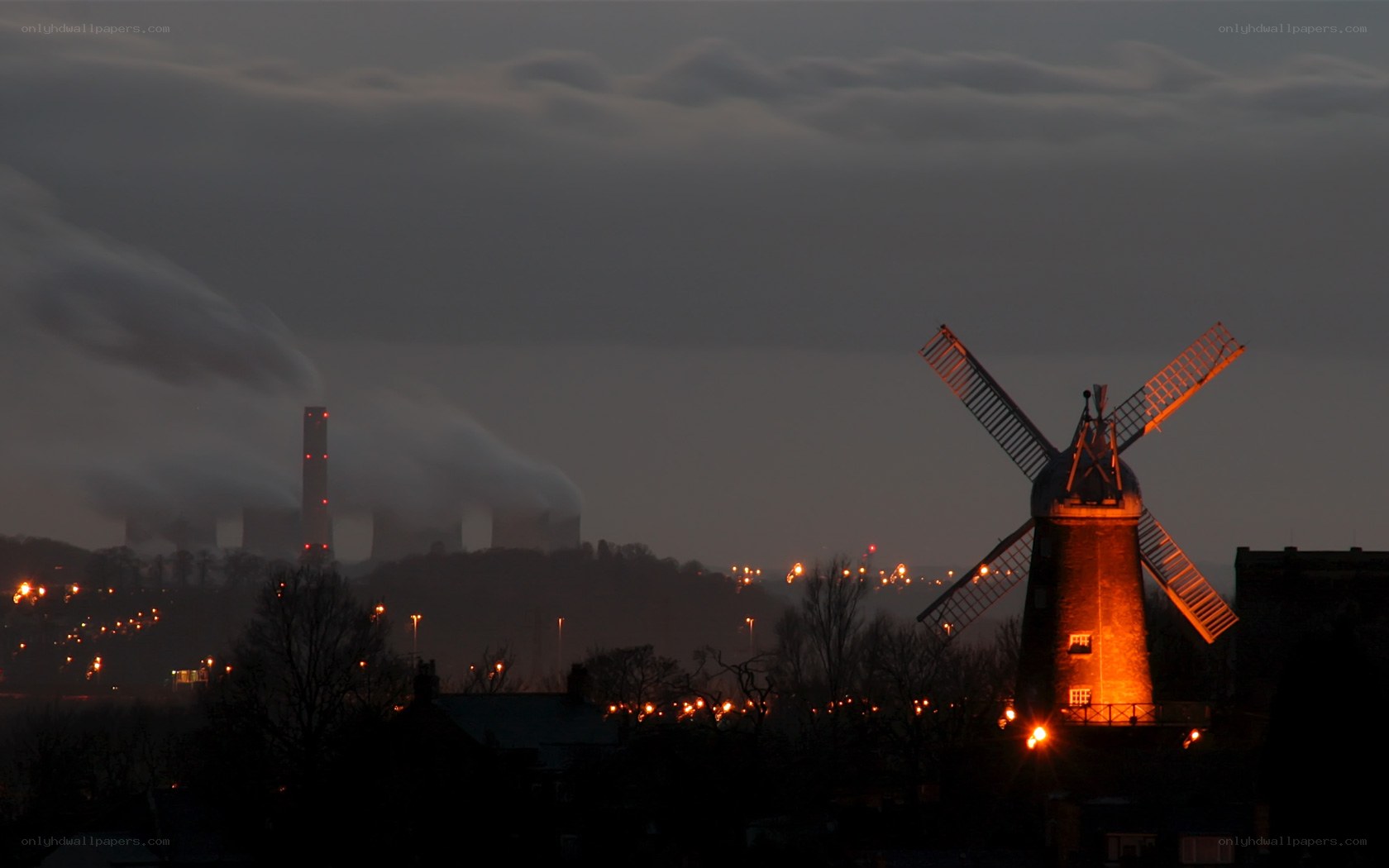 windmill at dusk with industrial smoke