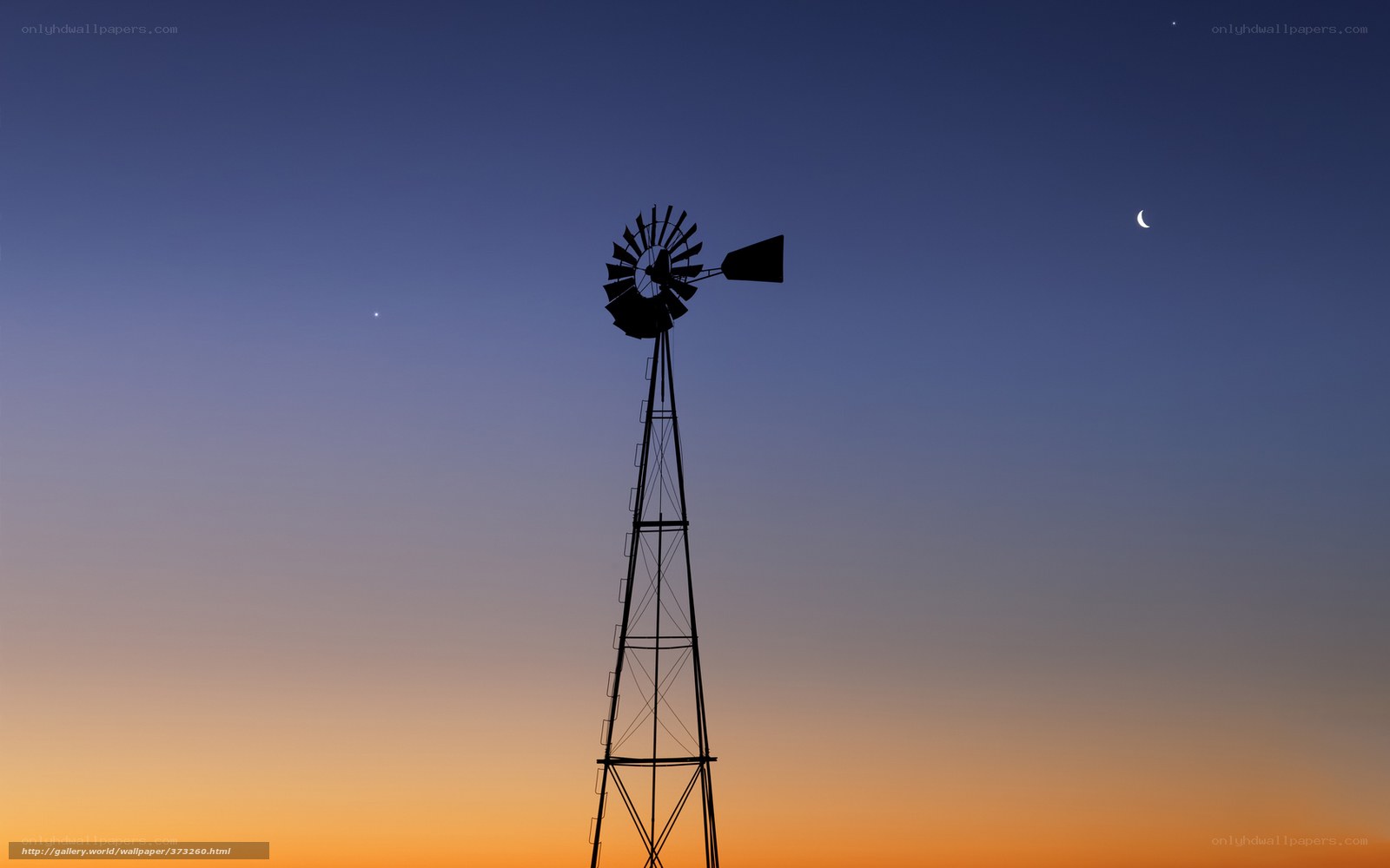 Windmill at dusk with moon and stars