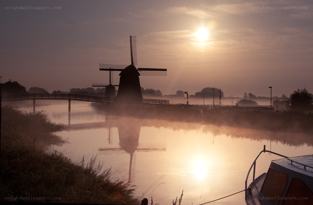 Windmill at sunrise over canal