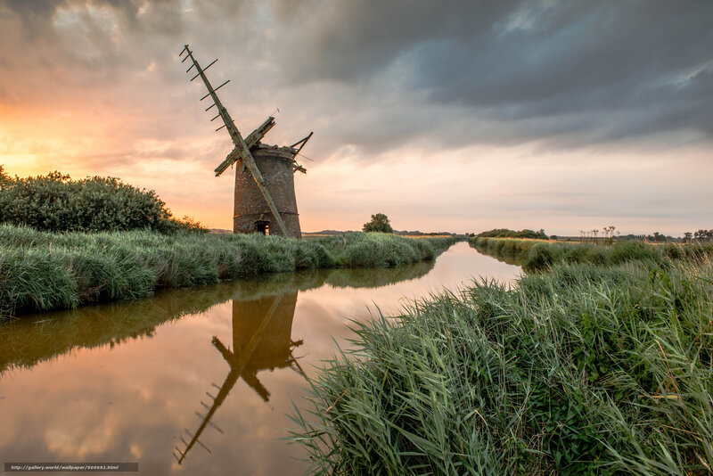 Windmill at sunset by a canal