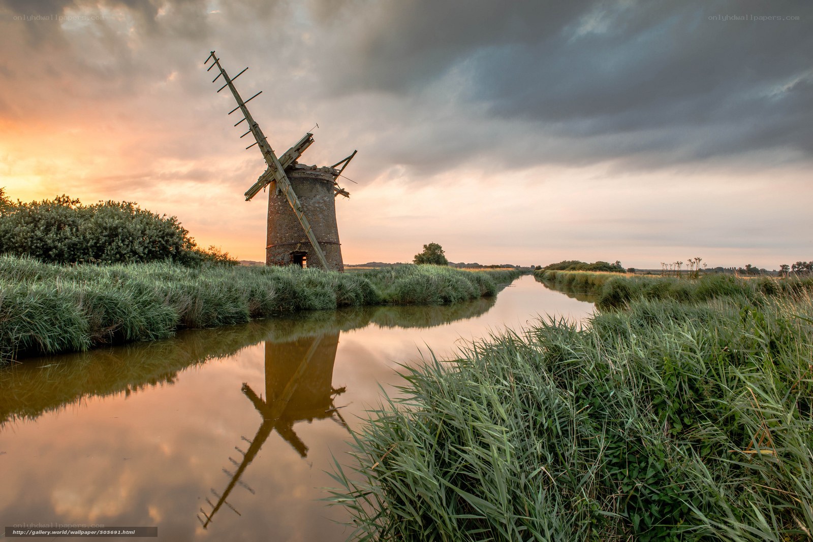 Windmill at sunset by a canal