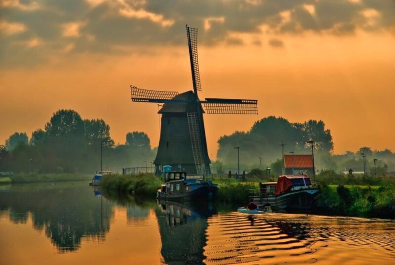 Windmill at sunset by the canal