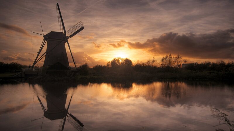 Windmill at sunset by the water
