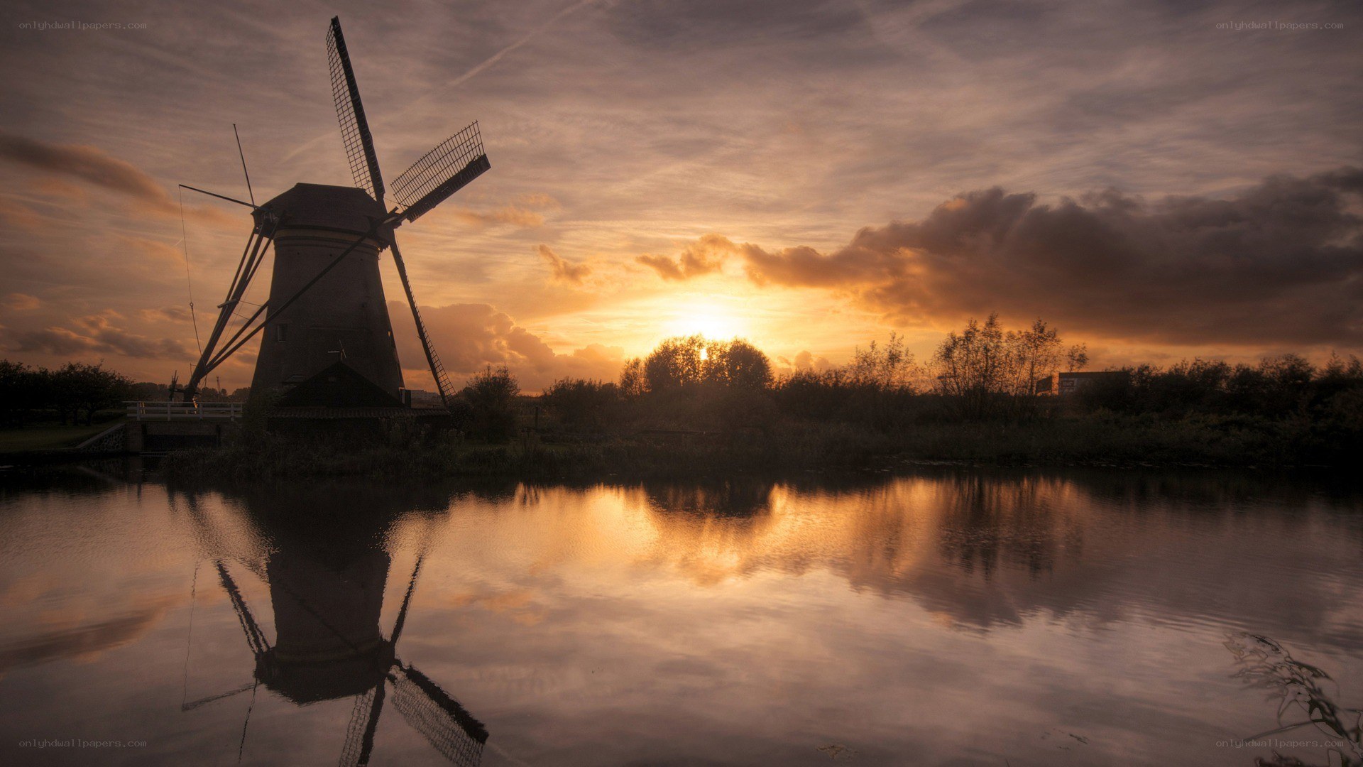 Windmill at sunset by the water
