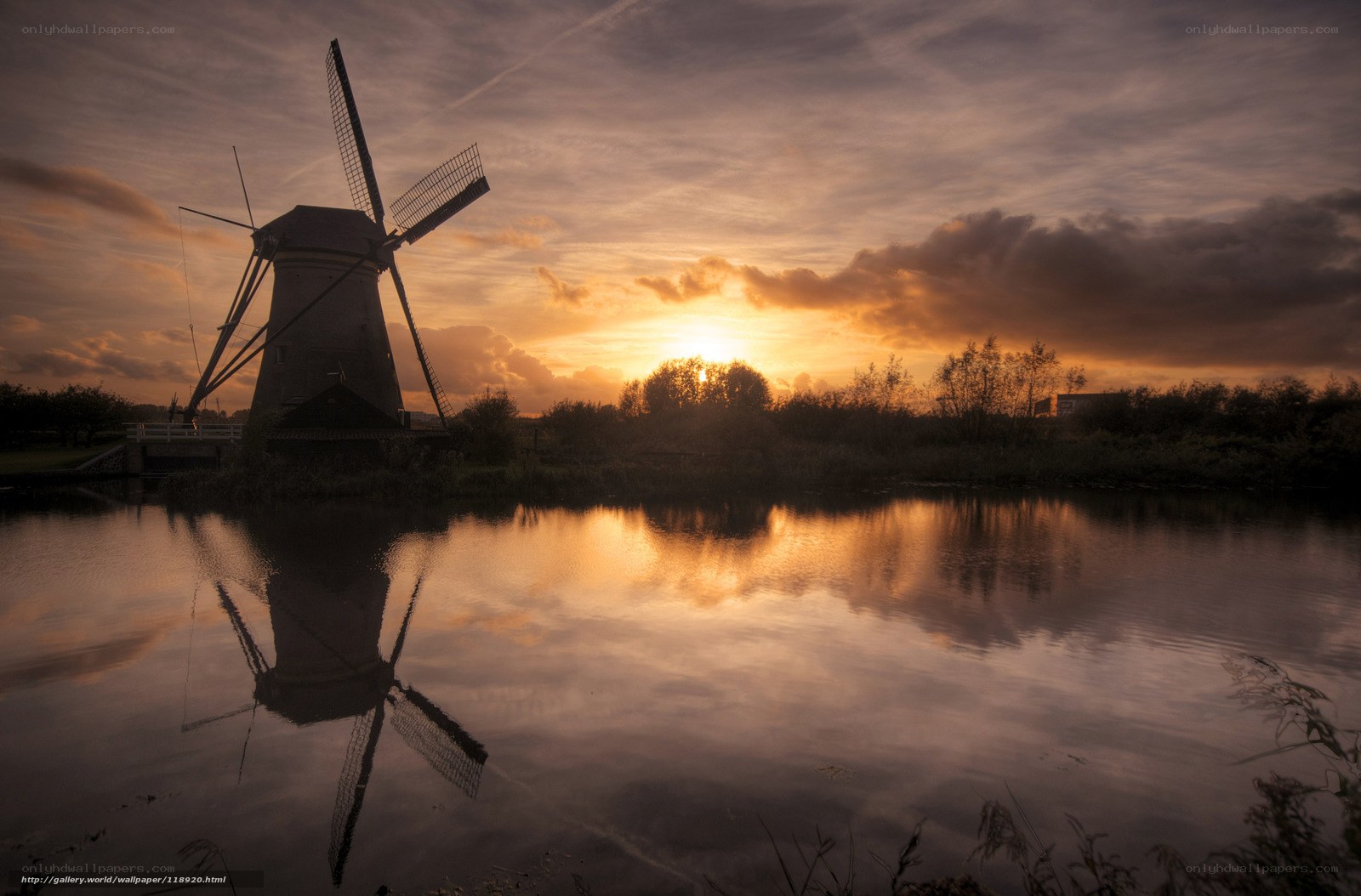 Windmill at sunset by the water