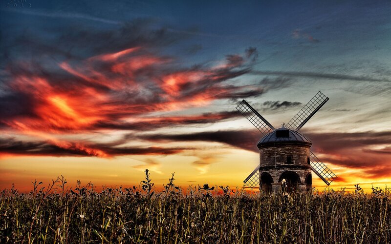 Windmill at sunset in a field