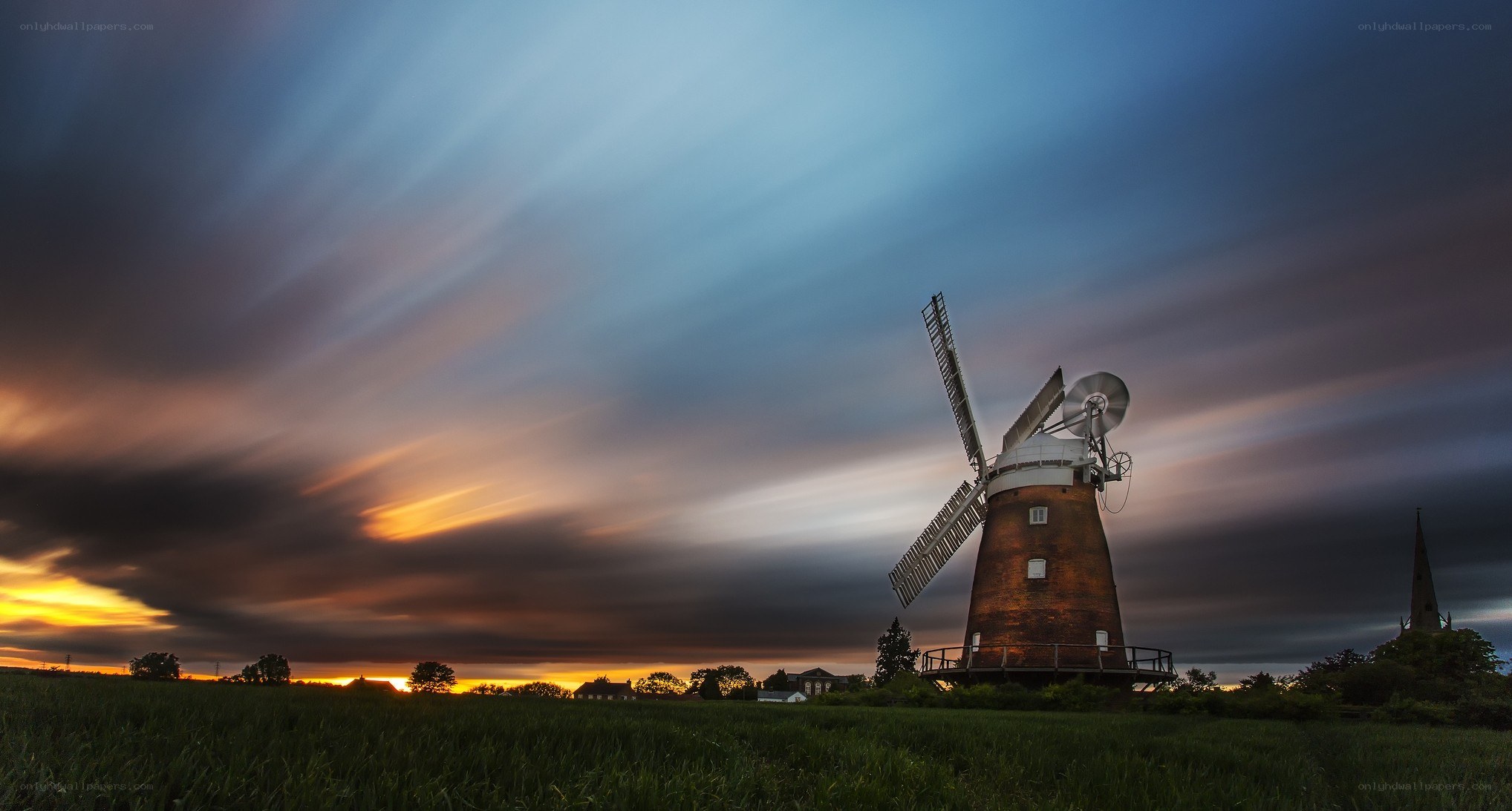 Windmill at sunset in a field