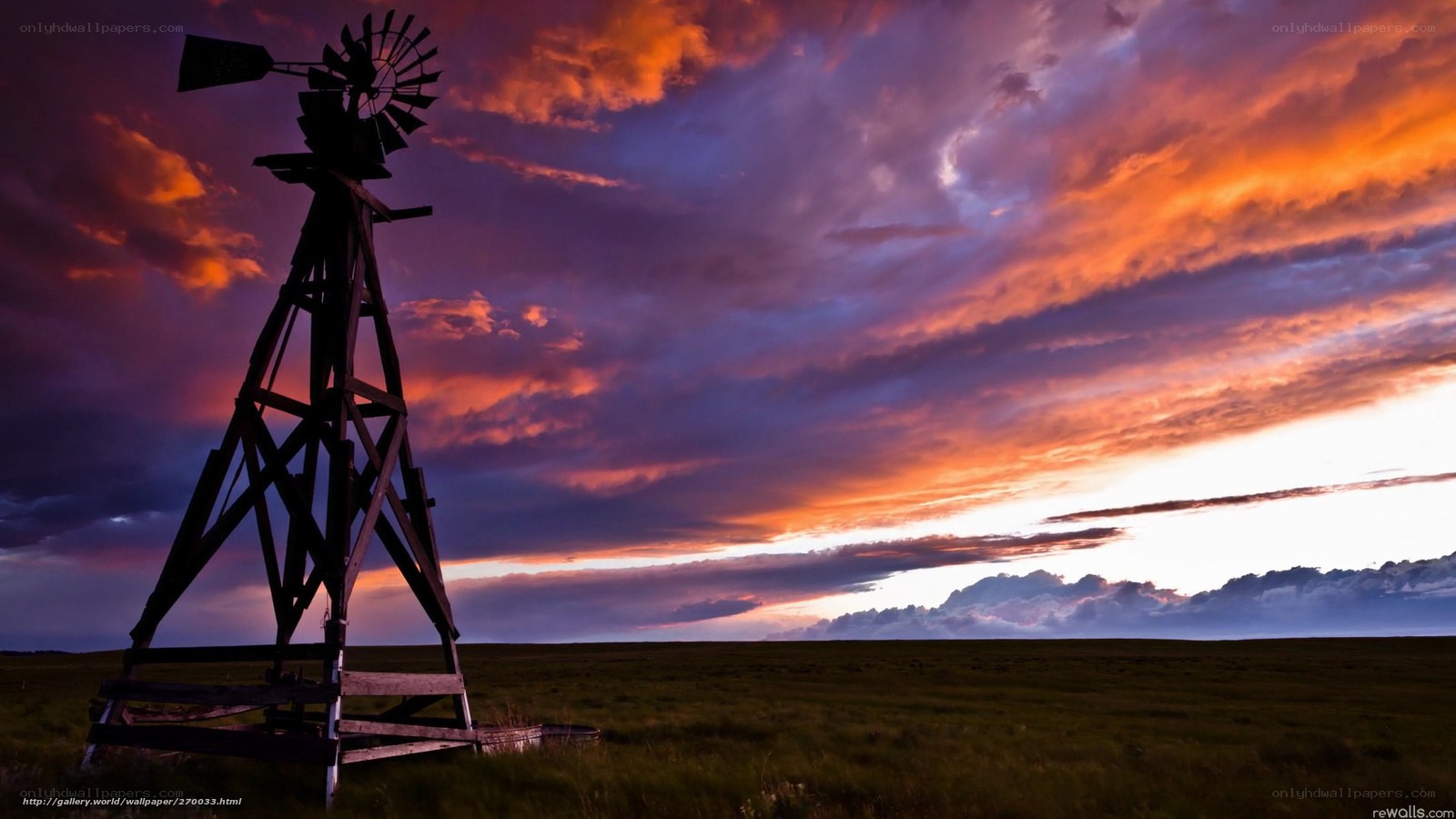 Windmill at sunset in a field