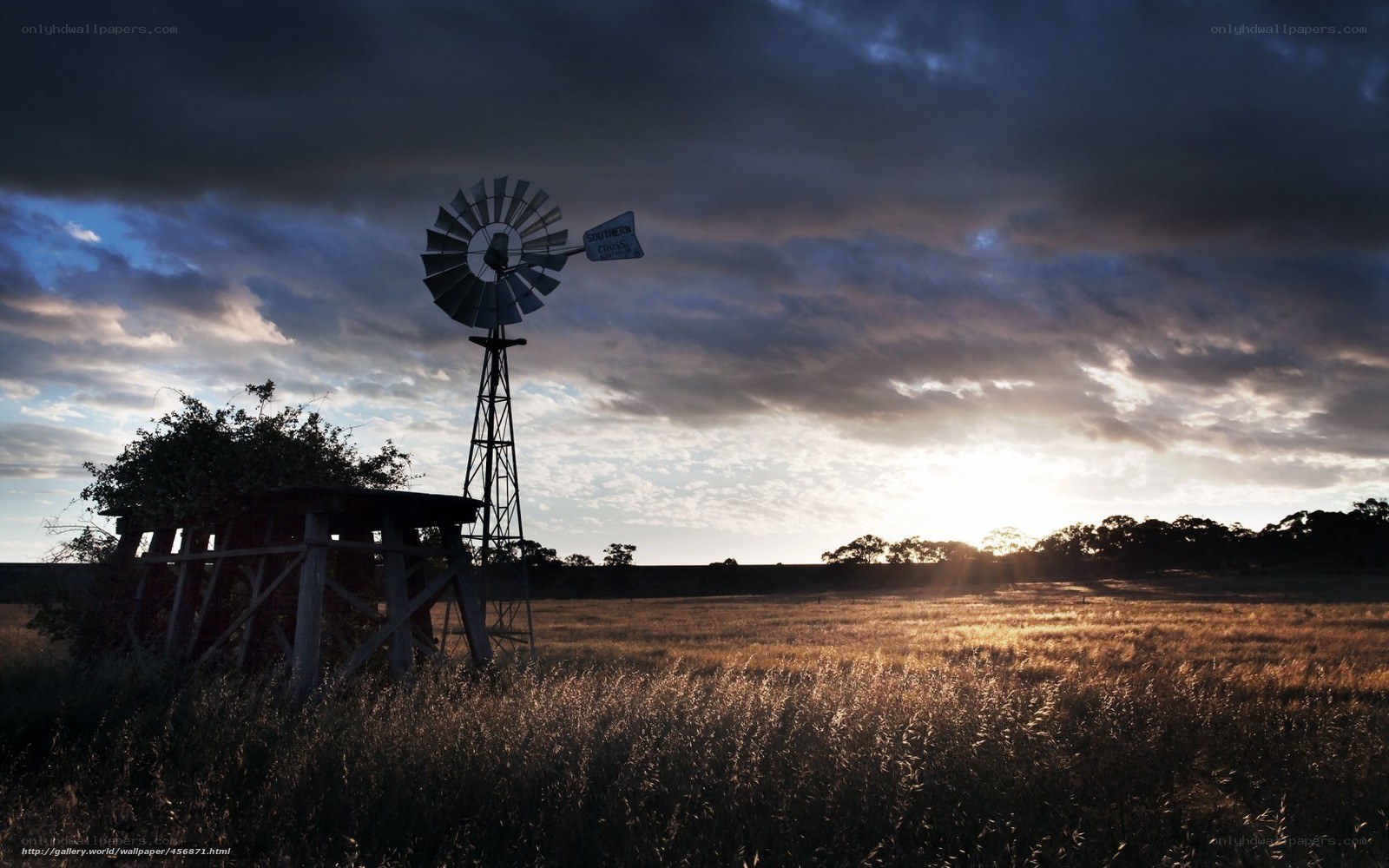 Windmill at sunset in a field