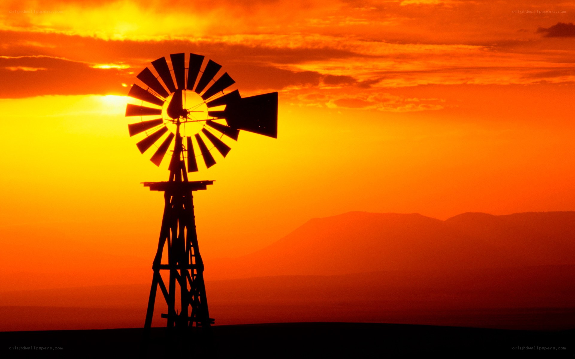 Windmill at sunset silhouette