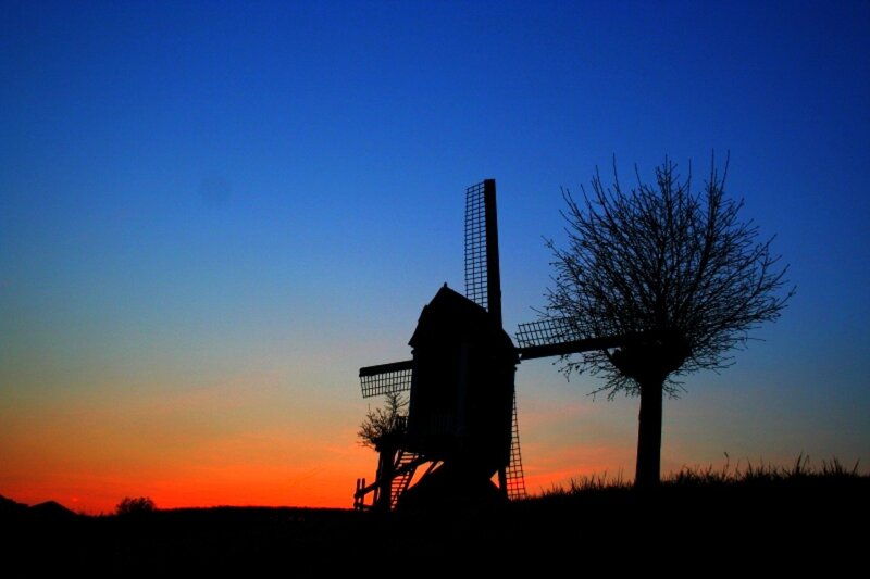 Windmill at sunset silhouette