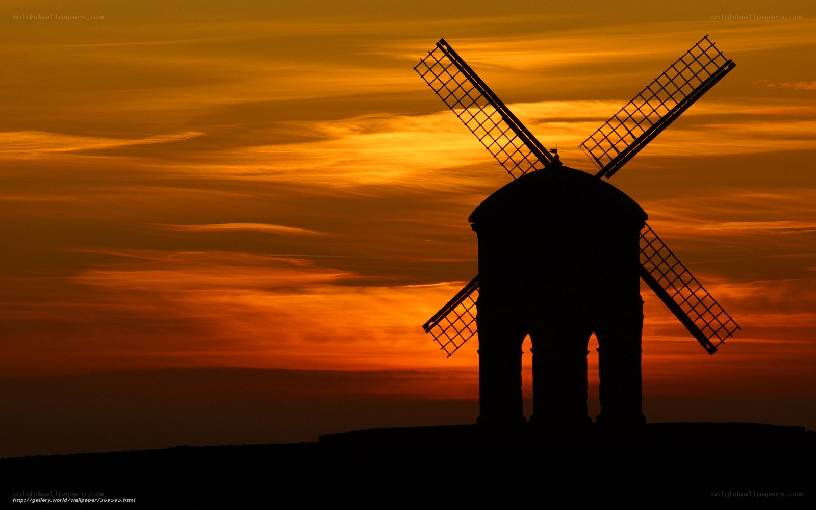 Windmill at sunset silhouette