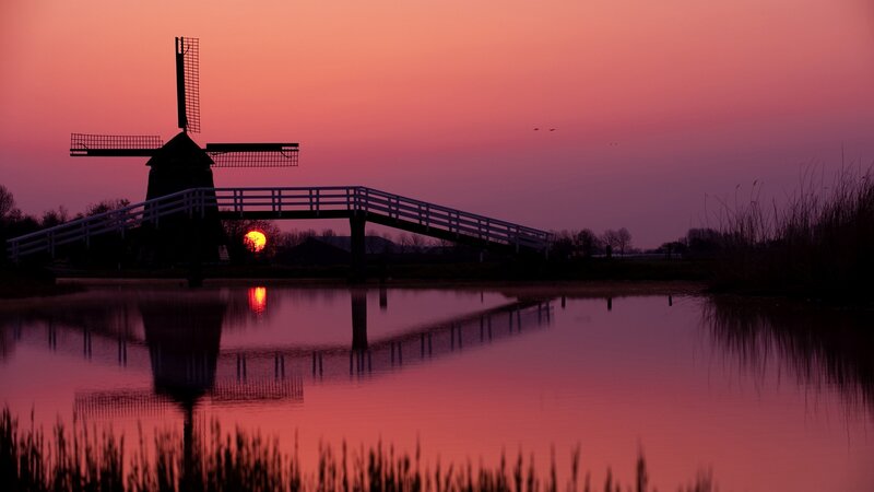 Windmill at sunset with bridge