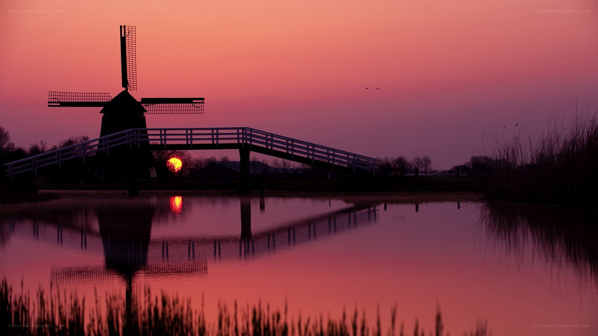 Windmill at sunset with bridge