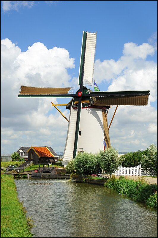 Windmill by a canal in the Netherlands