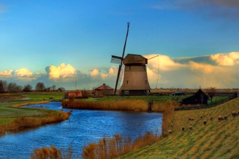 Windmill by a canal in the Netherlands