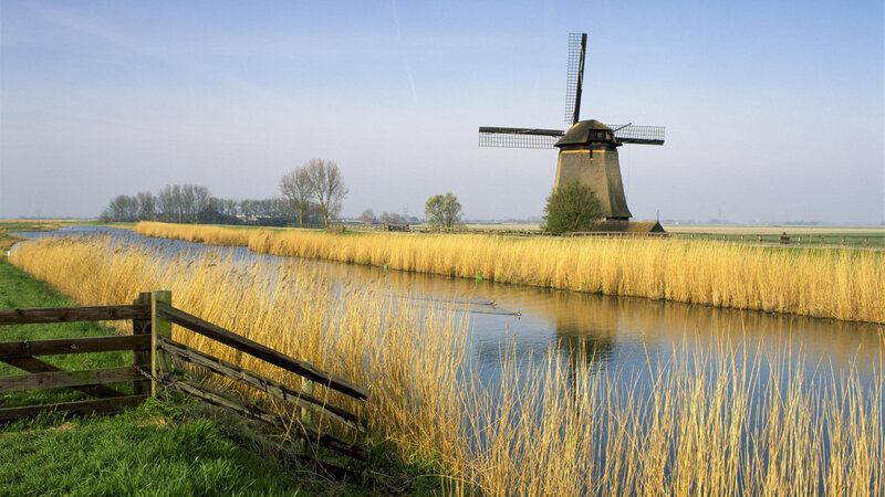 Windmill by a canal in the Netherlands