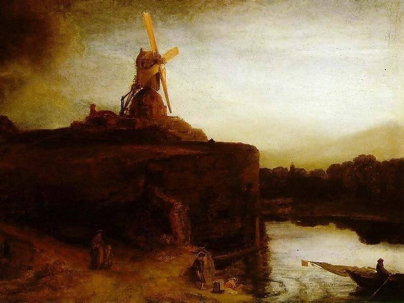 Windmill by a river at dusk