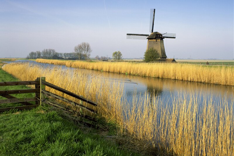 Windmill by Canal — Blue, Serene, Afternoon, Photograph, Reeds, Fence, Ducks