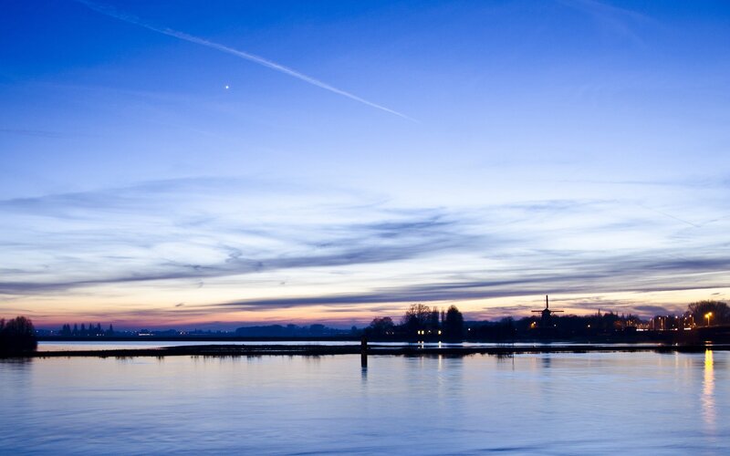 Windmill by River at Dusk