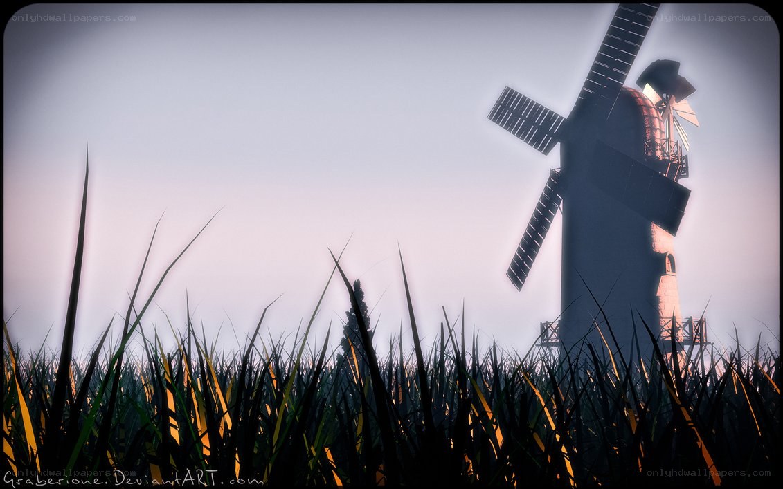 Windmill in a field at dusk