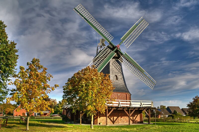 Windmill in autumn landscape