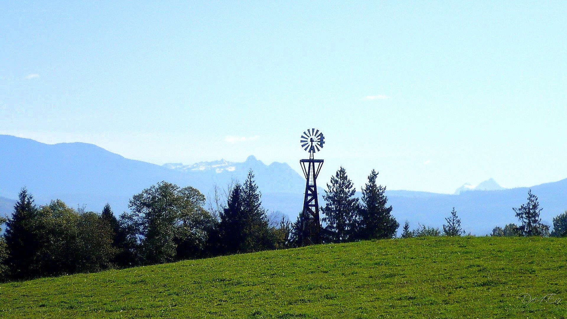 Windmill on a green hill