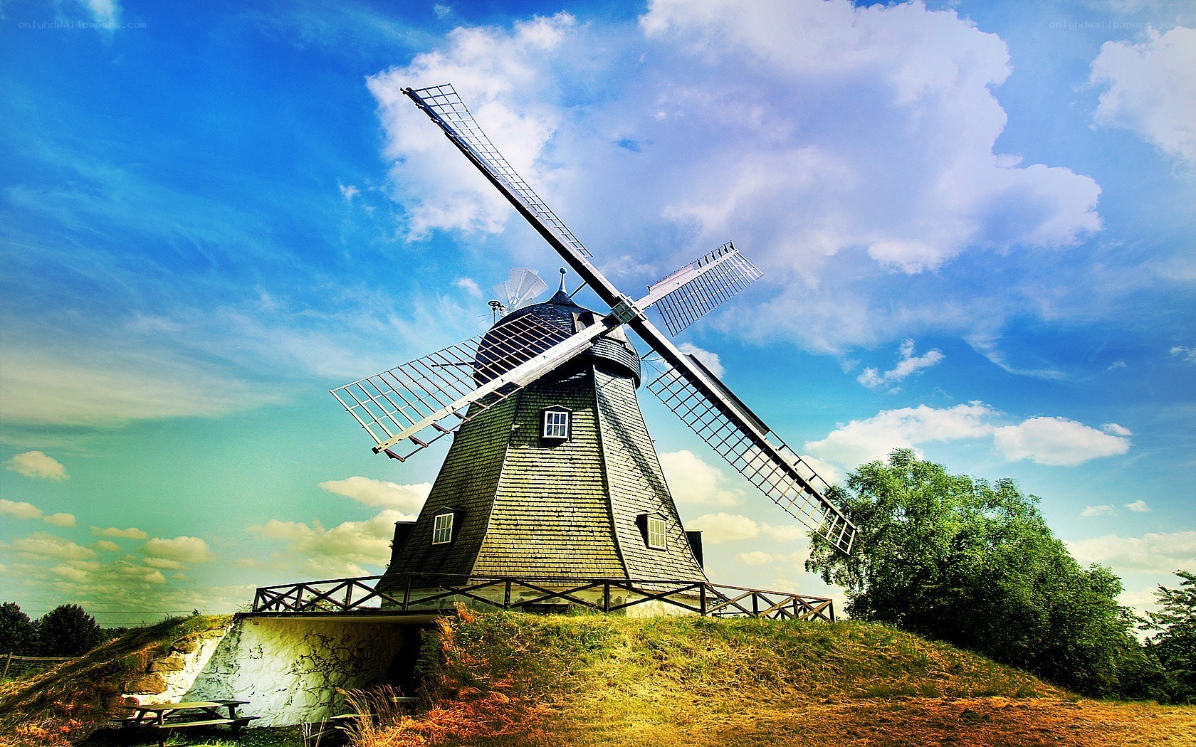 Windmill on a hill under blue sky